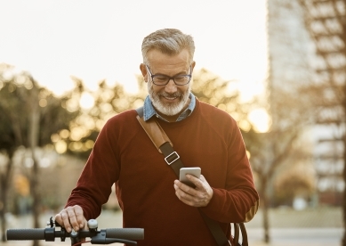 man with bike looking at phone